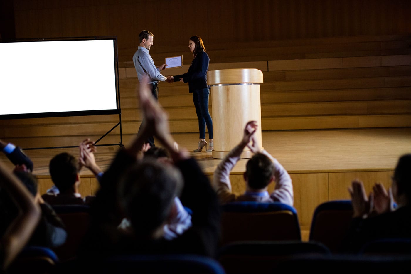 Award ceremony on stage with the audience applauding