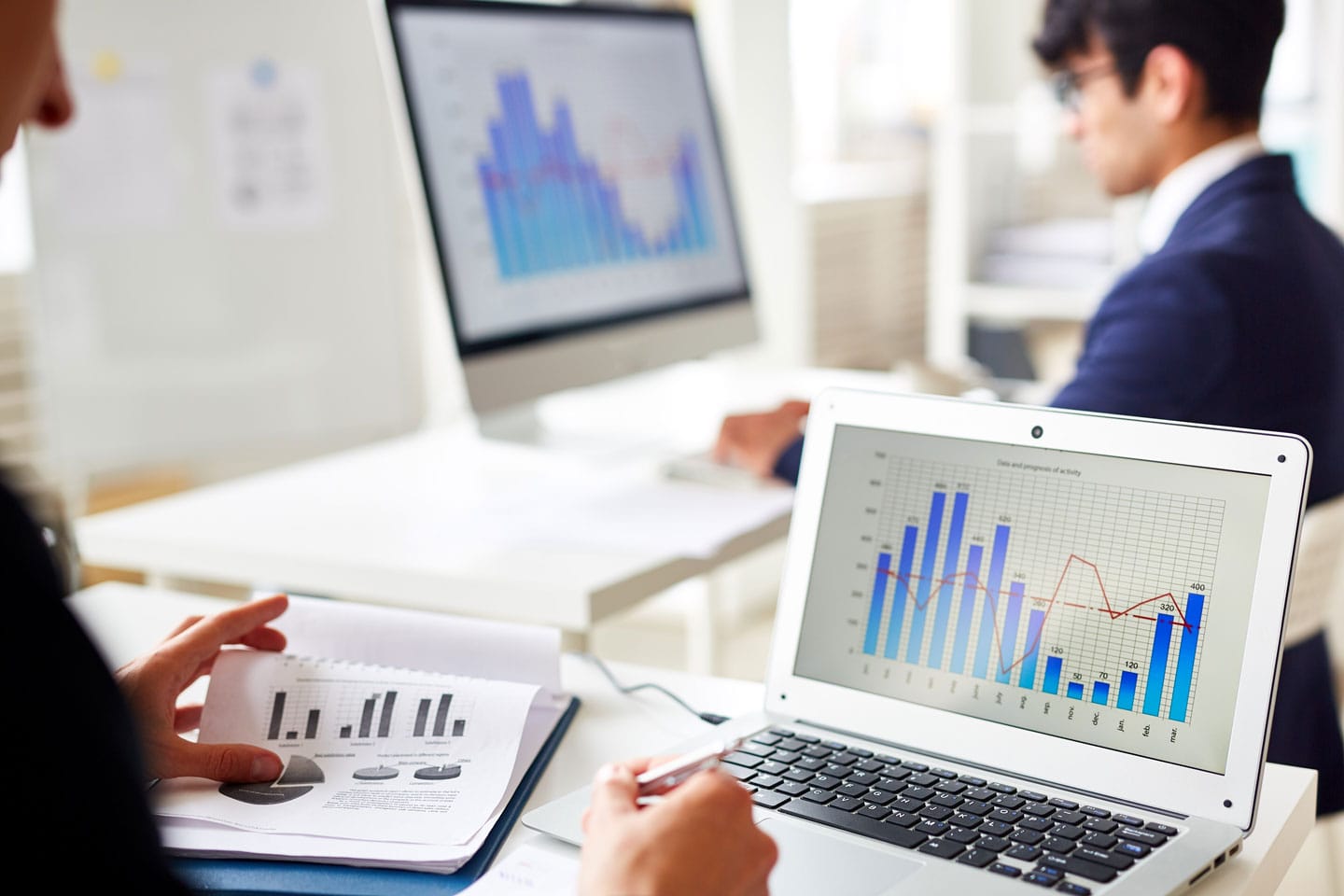 Performance charts on a laptop and desktop monitor