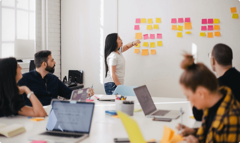 Team planning session with sticky notes on a whiteboard