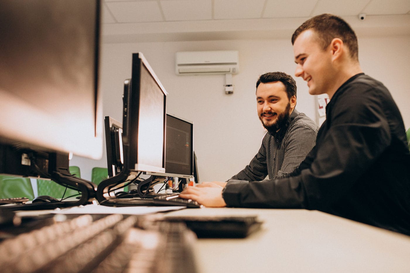Two developers working together at their computers